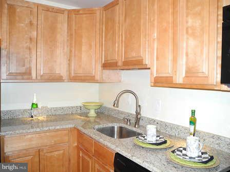 323 Leyton Road Reisterstown, MD 21136 - Photo 6 of 29 a kitchen with a granite countertop sink and cabinets