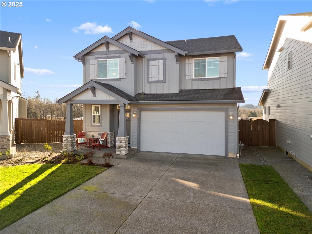 6684 North 89th Loop Camas, WA 98607 - Photo 1 of 44 a front view of a house with garden