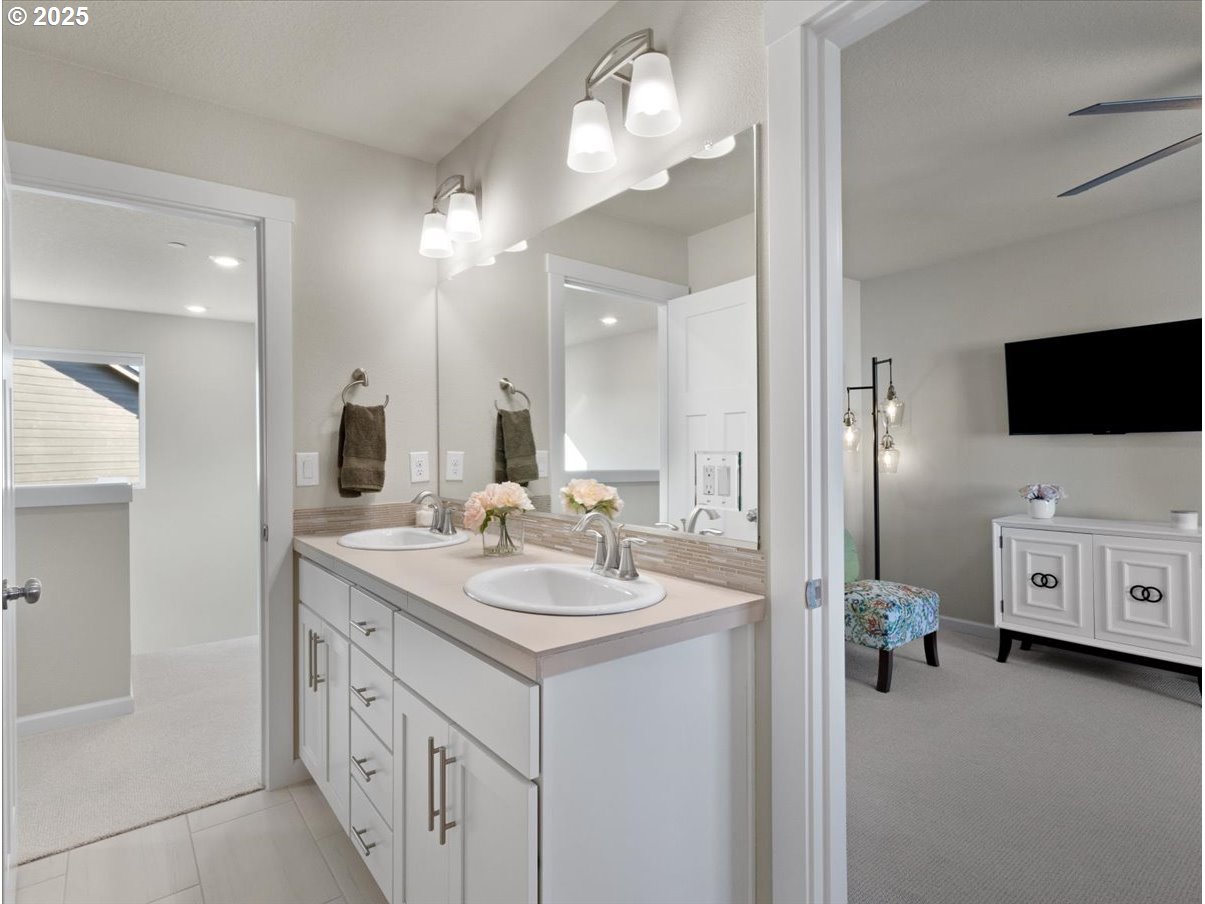 6684 North 89th Loop Camas, WA 98607 - Photo 21 of 44 a bathroom with a double vanity sink and mirror