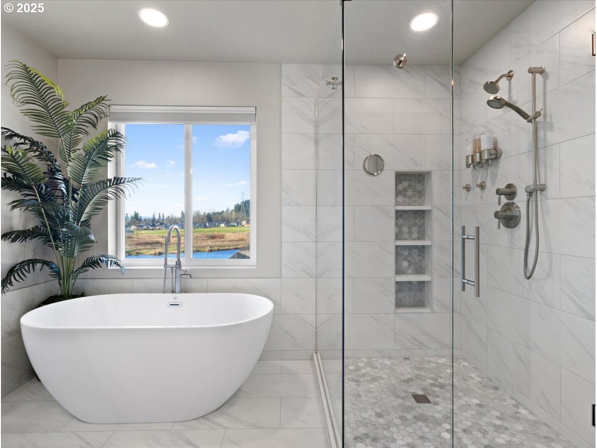 6684 North 89th Loop Camas, WA 98607 - Photo 28 of 44 a bathroom with a tub and shower
