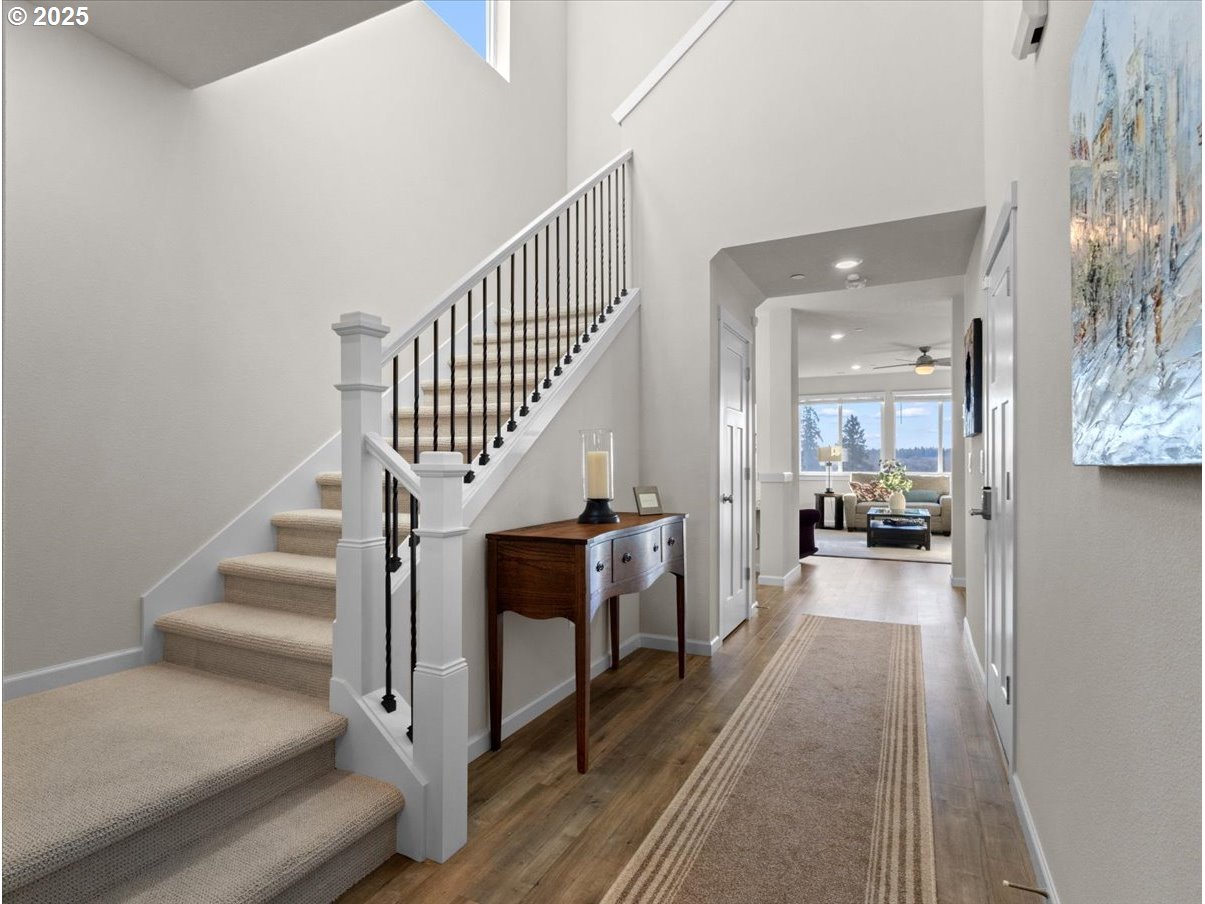 6684 North 89th Loop Camas, WA 98607 - Photo 4 of 44 a view of a hallway with wooden floor and staircase