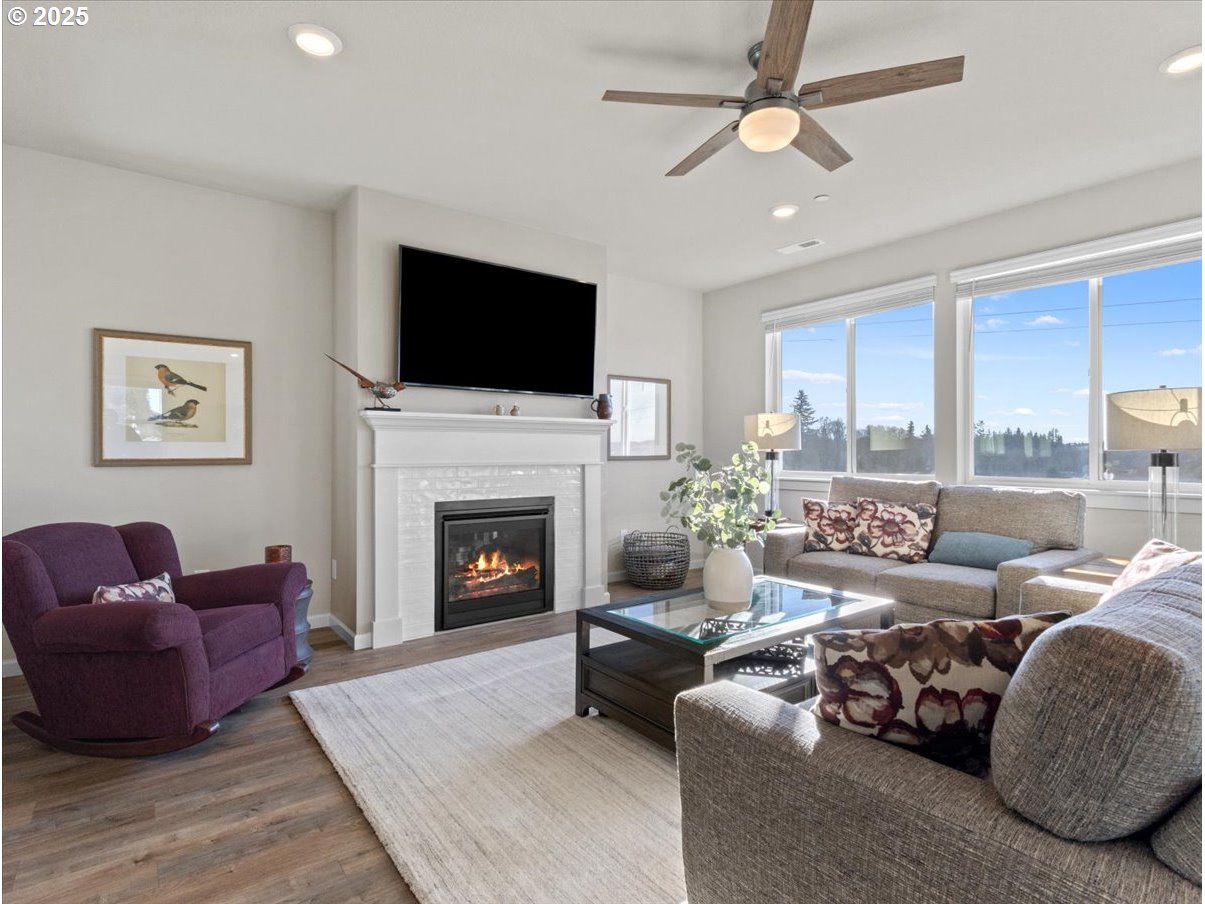 6684 North 89th Loop Camas, WA 98607 - Photo 8 of 44 a living room with furniture a fireplace and a flat screen tv
