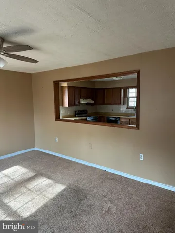 a view of a livingroom with an empty space and a fireplace