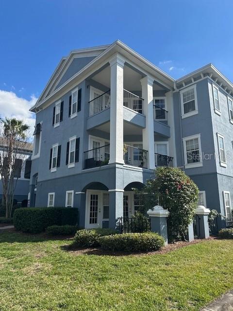 3735 Conroy Road, Unit 2217 Orlando, FL 32839 - Photo 1 of 1 a front view of a residential apartment building with a yard