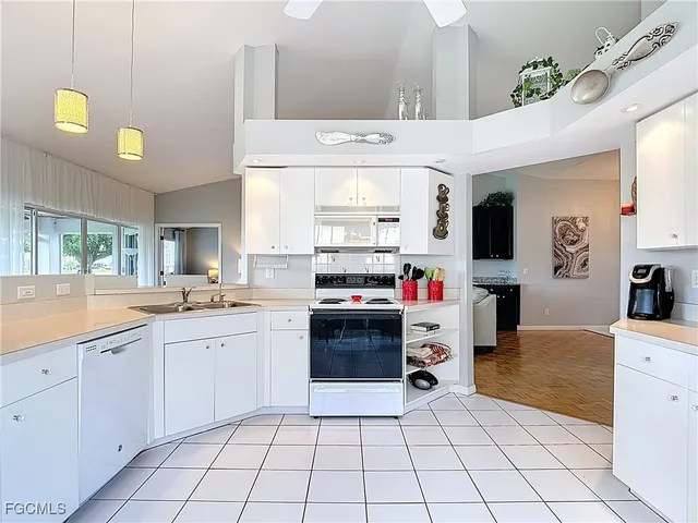 a kitchen with a sink and white cabinets