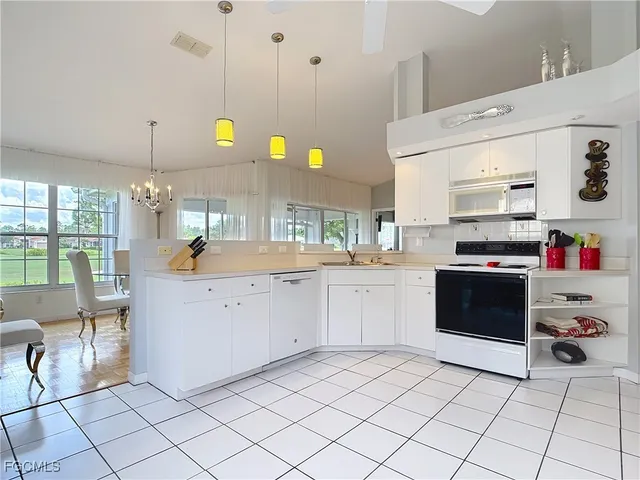 a kitchen with cabinets and appliances