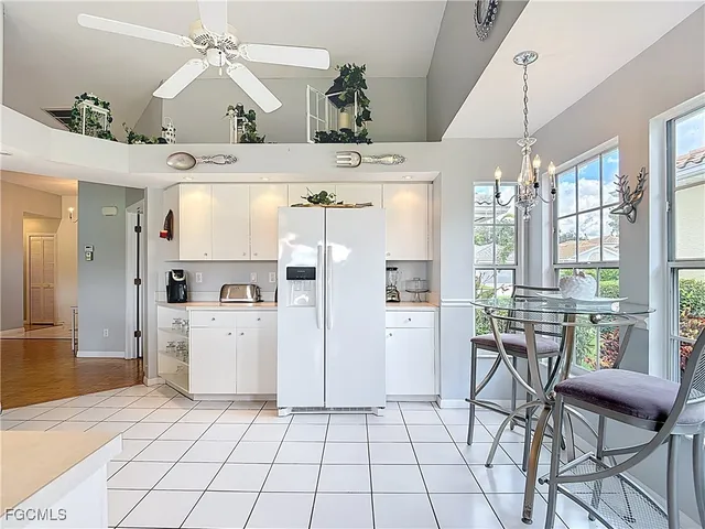 a view of a dining room with furniture and chandelier