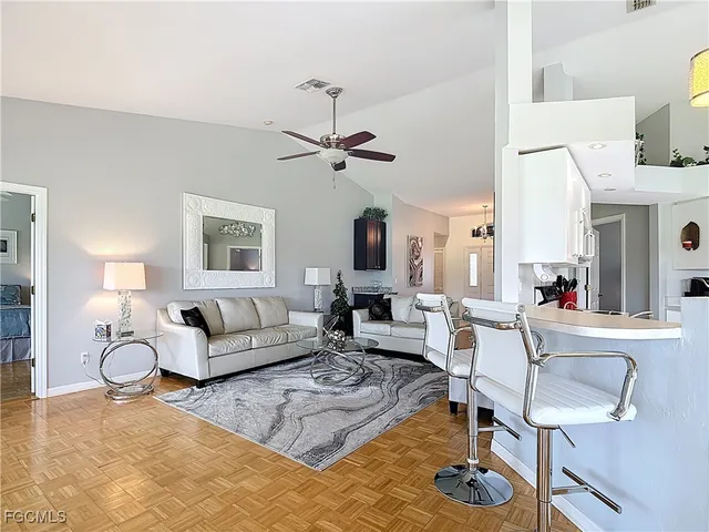 a living room with furniture a chandelier and a window