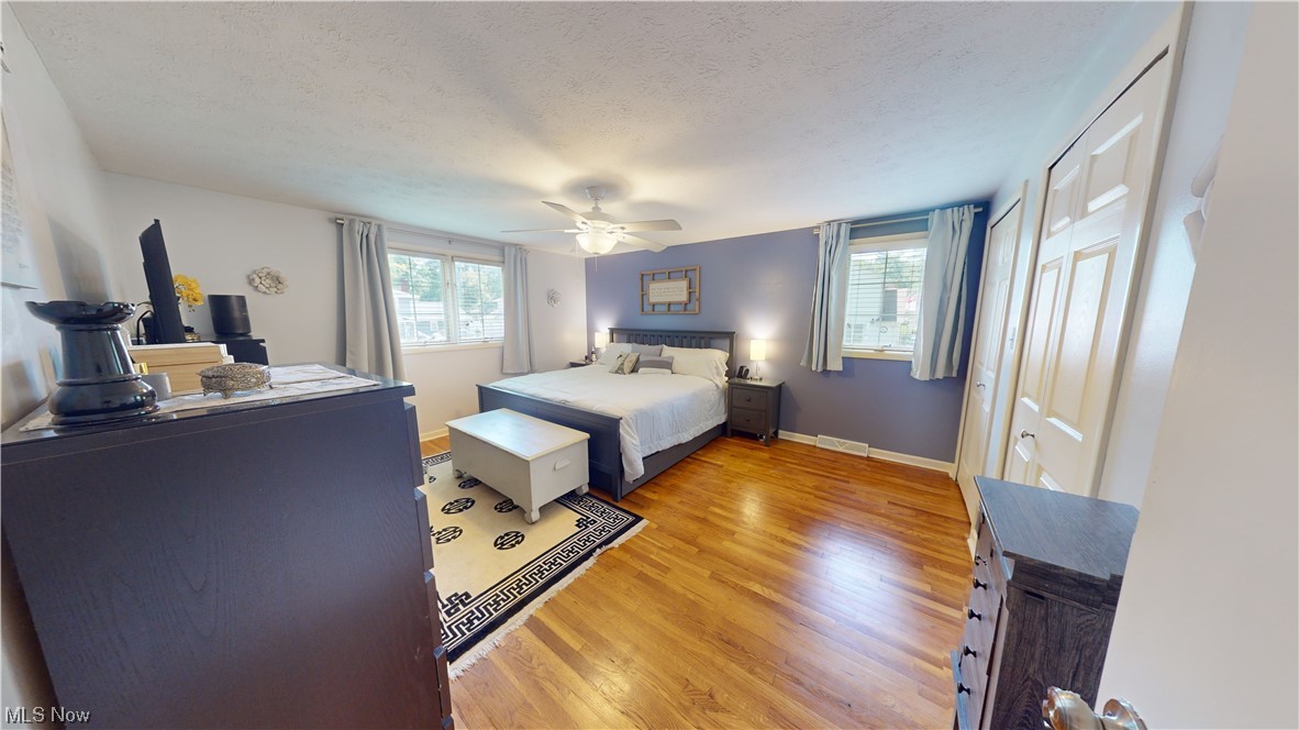 1071 Roland Road Lyndhurst, OH 44124 - Photo 20 of 30 Bedroom featuring ceiling fan, light hardwood floors, and a textured ceiling