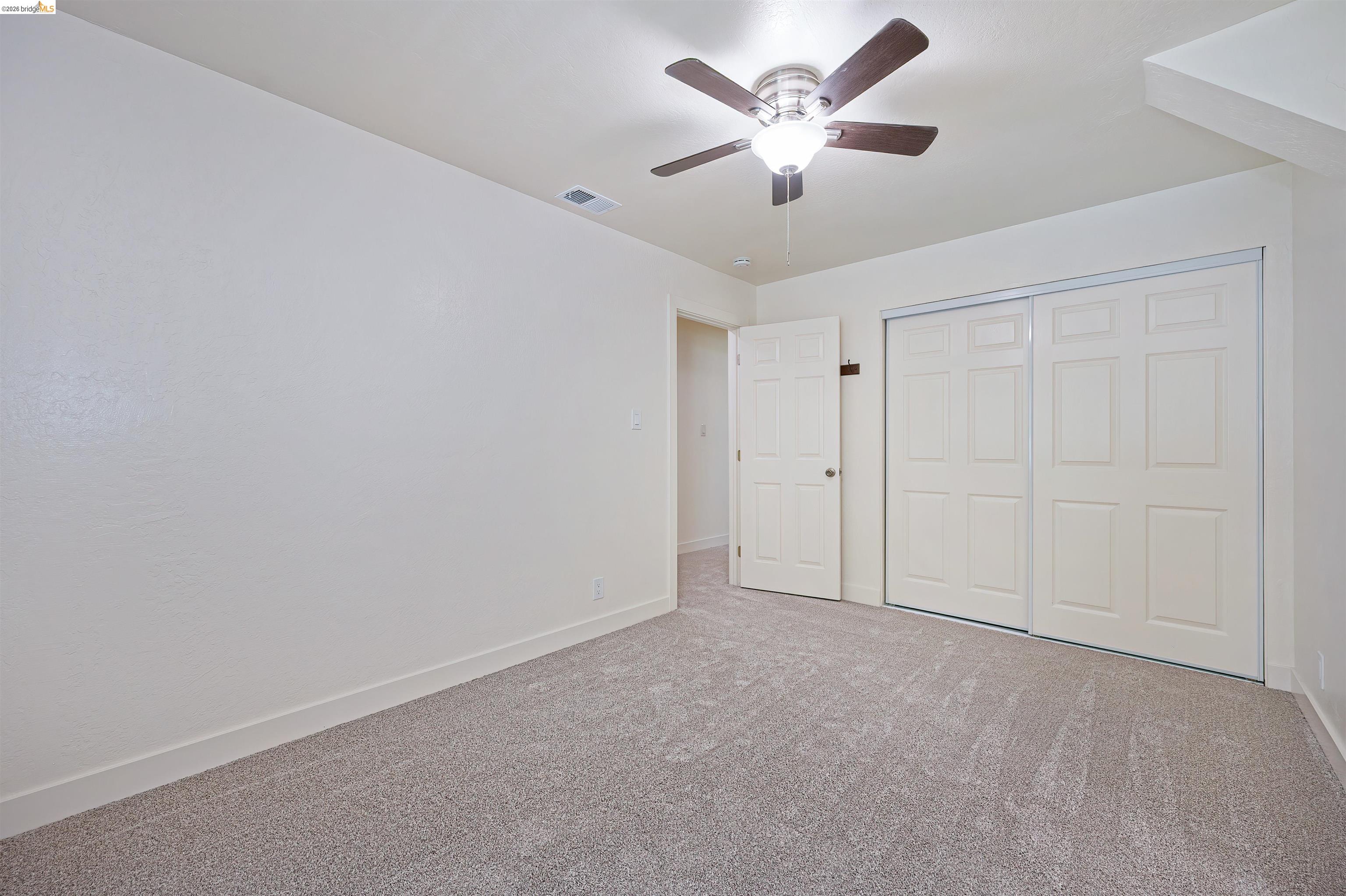 10474 Sheldon Road Elk Grove, CA 95624 - Photo 29 of 83 Neutral-toned carpeting extends throughout the room, complemented by white walls and trim