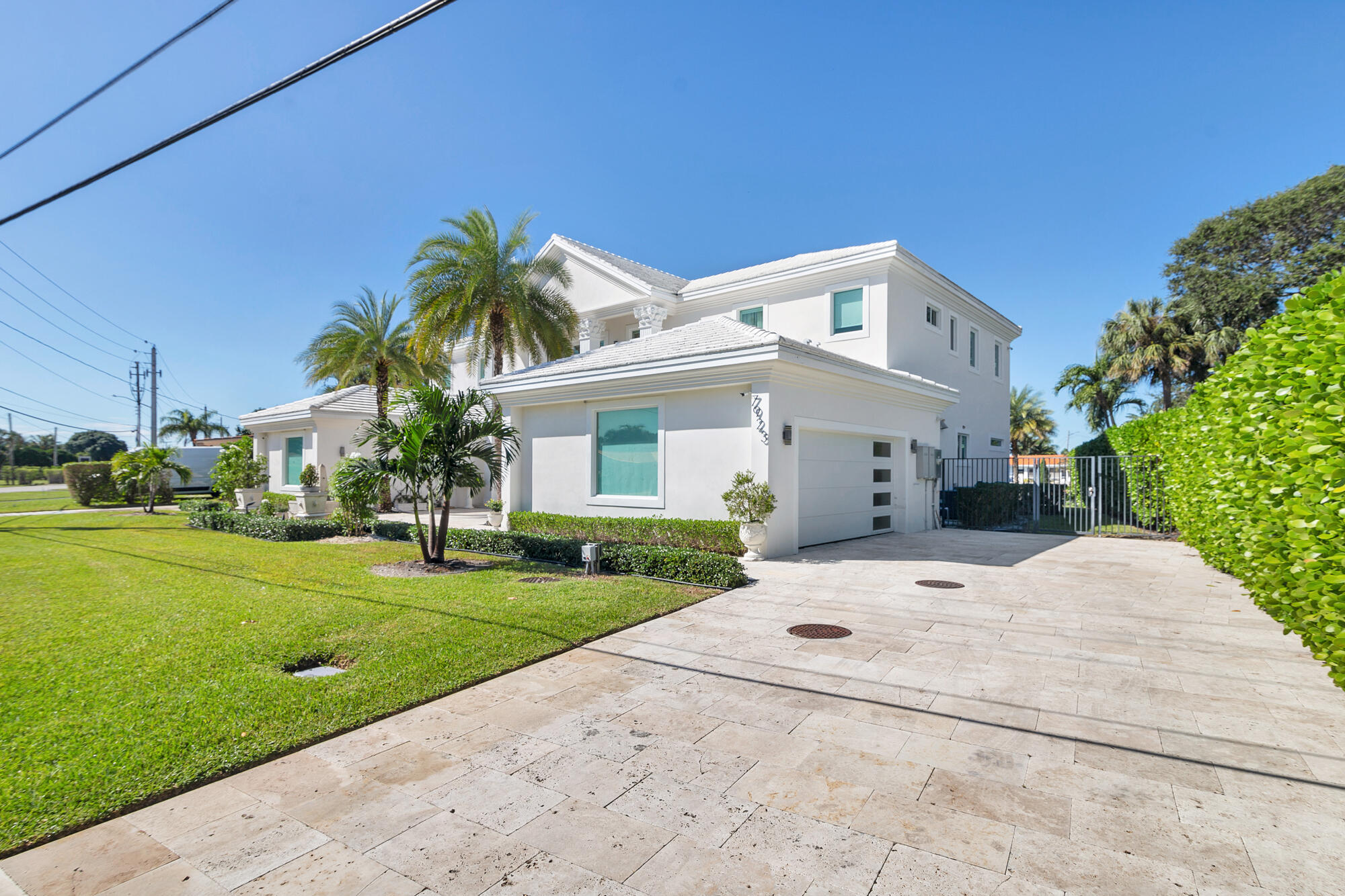 7923 Pine Tree Lane Lake Clarke Shores, FL 33406 - Photo 12 of 70 a front view of a house with a yard