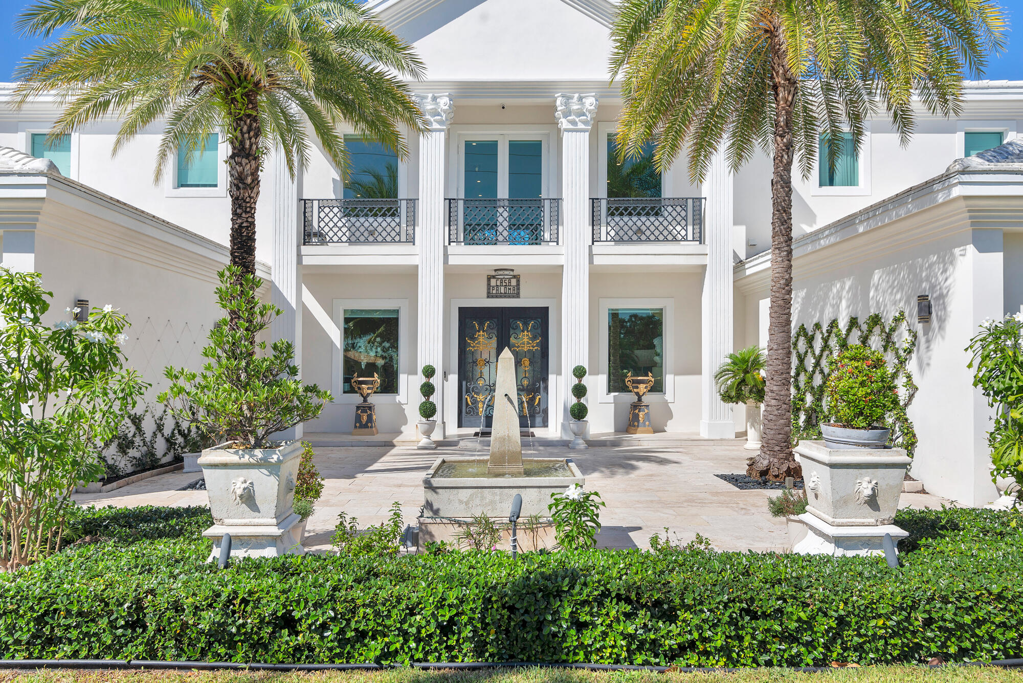 7923 Pine Tree Lane Lake Clarke Shores, FL 33406 - Photo 15 of 70 a front view of a house with garden and trees