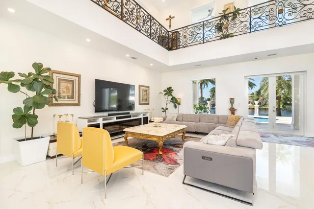 a living room with furniture and view of kitchen