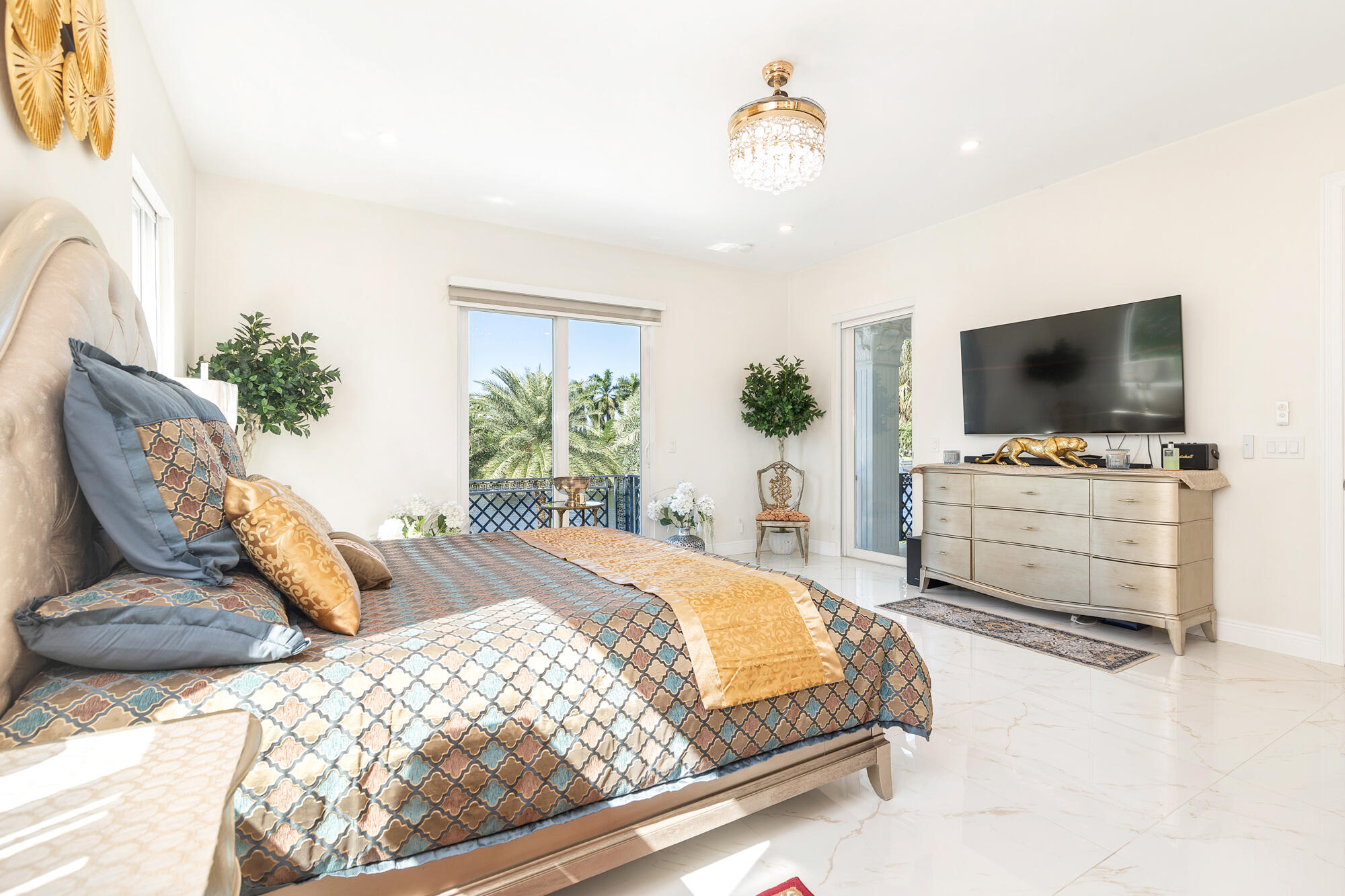 7923 Pine Tree Lane Lake Clarke Shores, FL 33406 - Photo 35 of 70 a bedroom with a bed and a flat screen tv