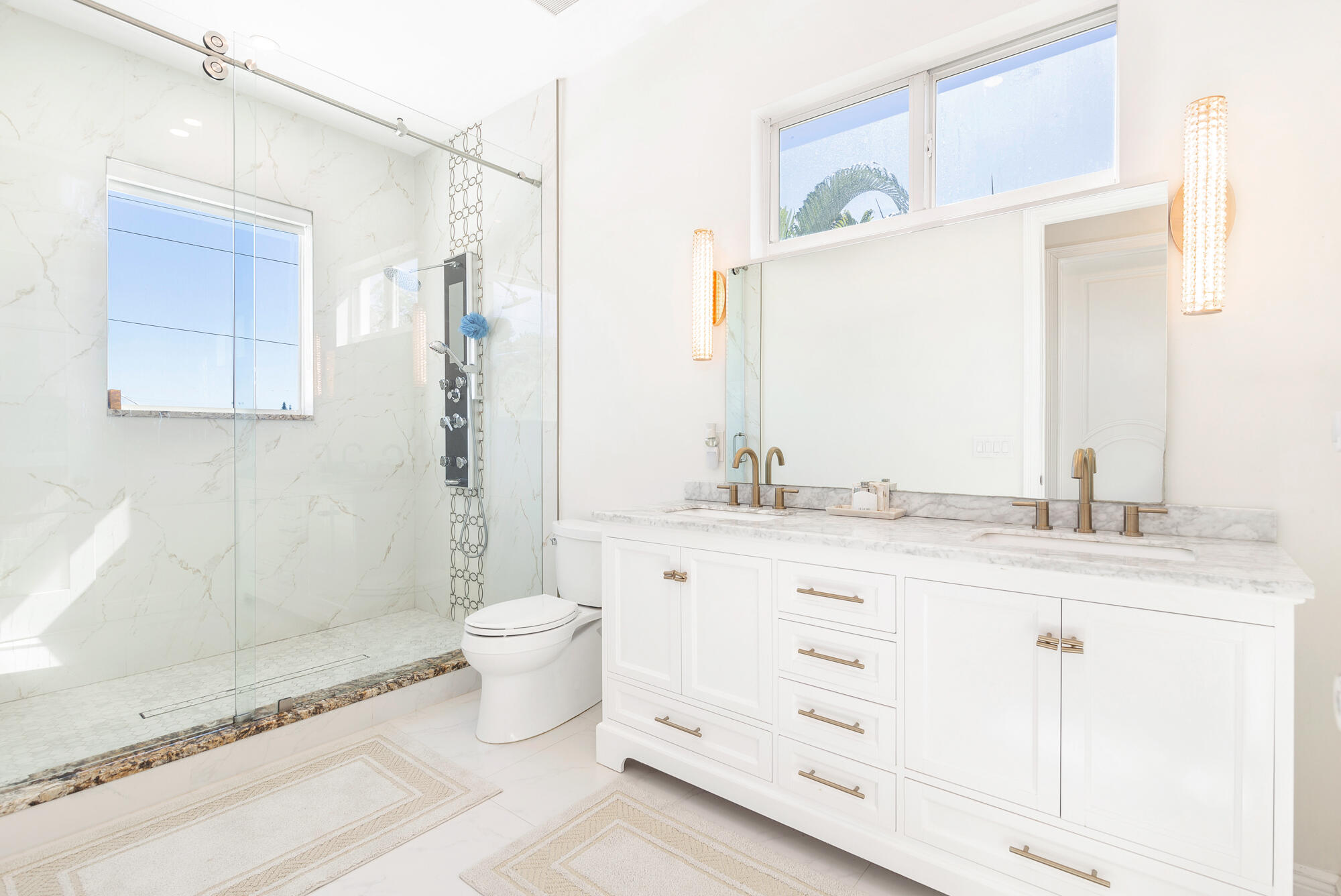 7923 Pine Tree Lane Lake Clarke Shores, FL 33406 - Photo 37 of 70 a bathroom with a granite countertop toilet sink and a mirror