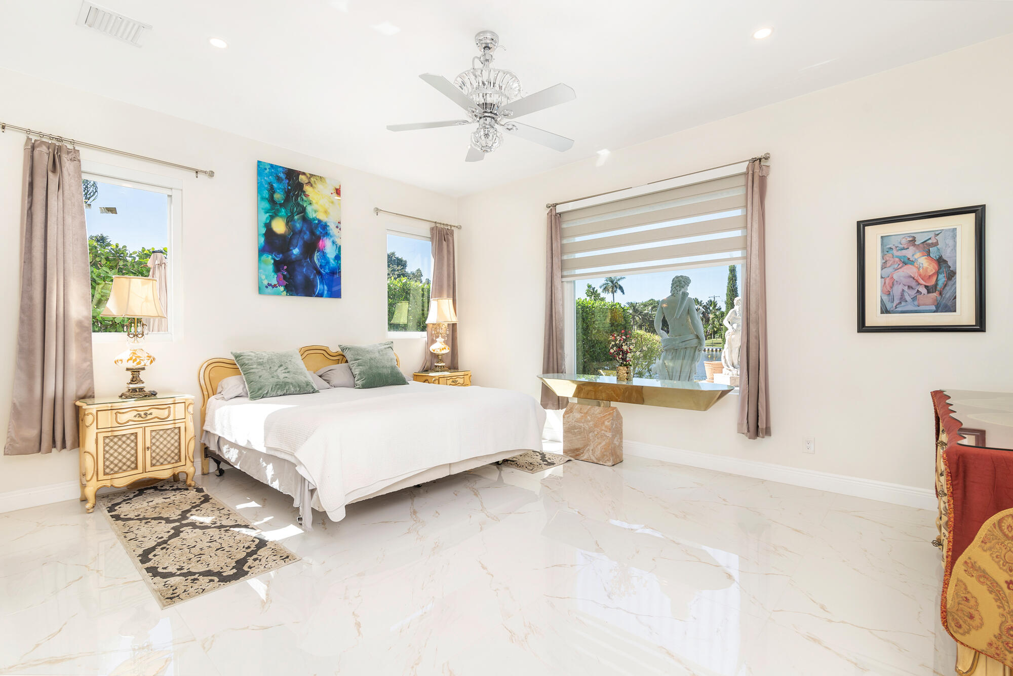 7923 Pine Tree Lane Lake Clarke Shores, FL 33406 - Photo 39 of 70 a spacious bedroom with a large bed and a window