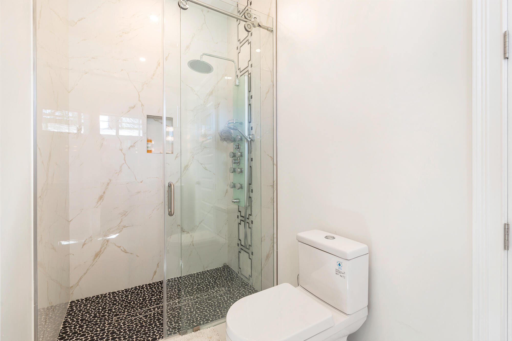 7923 Pine Tree Lane Lake Clarke Shores, FL 33406 - Photo 42 of 70 a bathroom with a toilet and shower