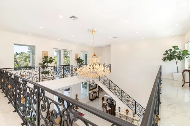 an aerial view of a house with garden space lake view and mountain view in back