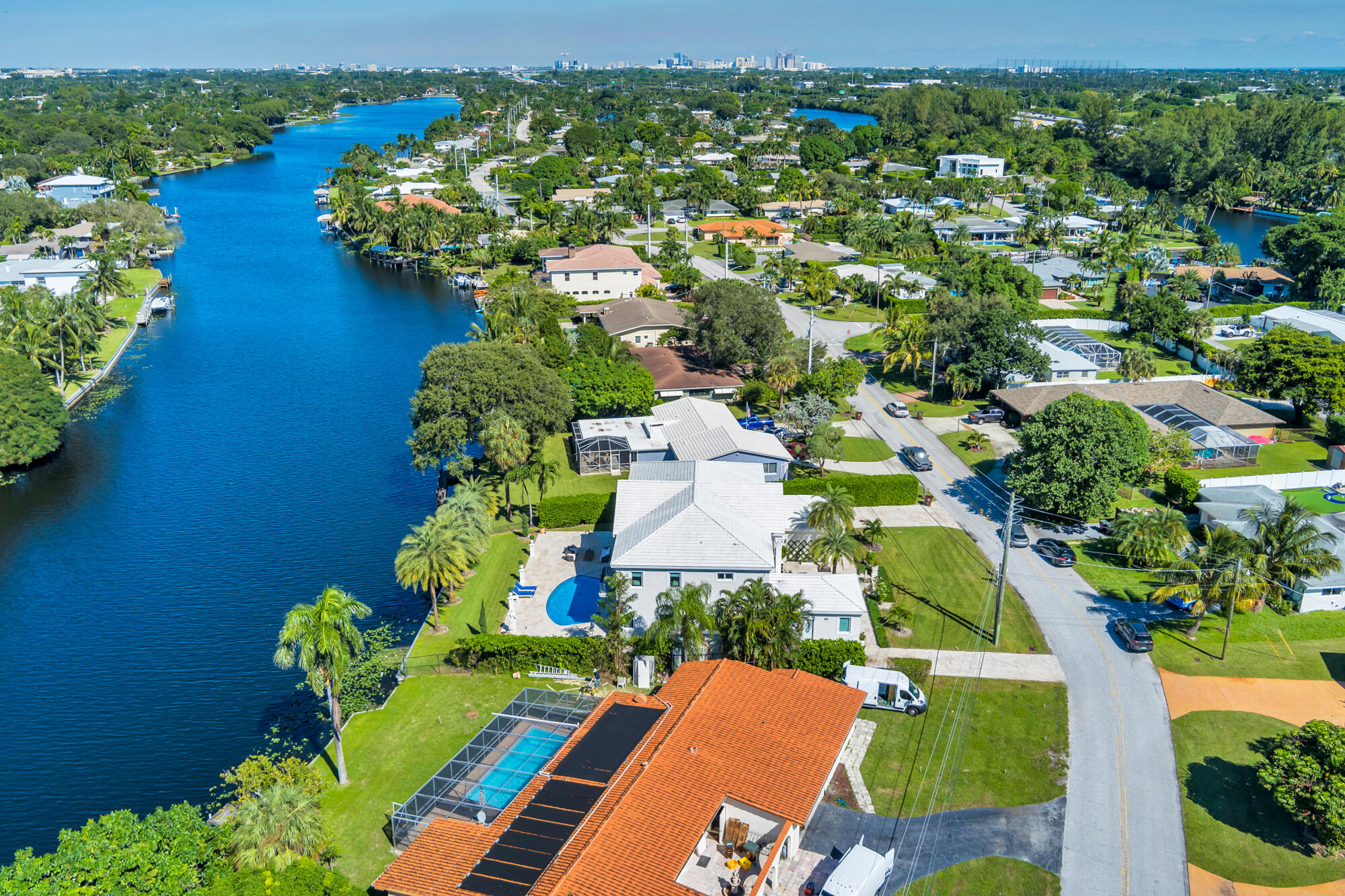 7923 Pine Tree Lane Lake Clarke Shores, FL 33406 - Photo 59 of 70 an aerial view of a house with a yard swimming pool outdoor seating and lake view