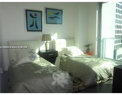 a bed sitting in a bedroom next to a window