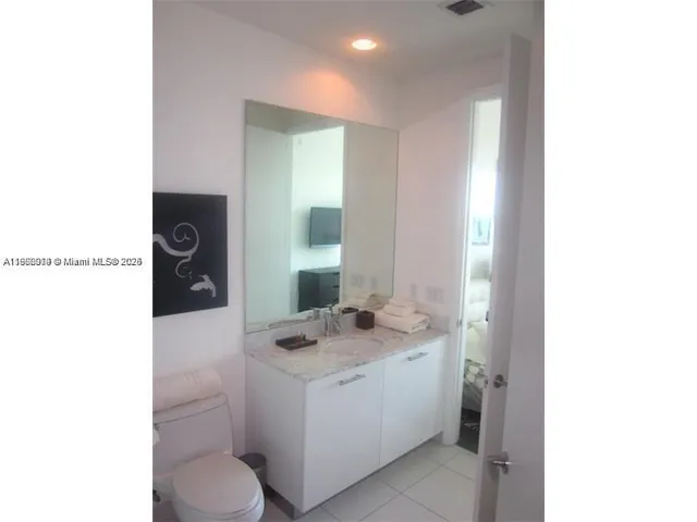 a bathroom with a sink a toilet and mirror