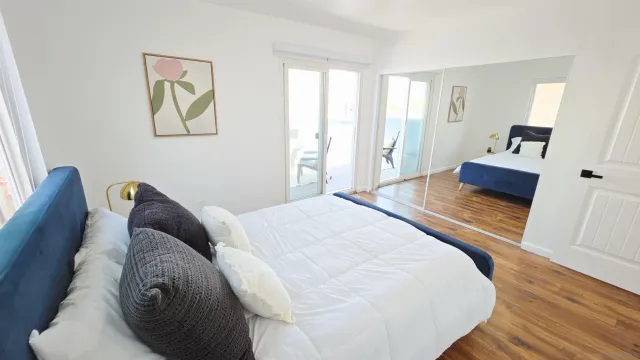 a bedroom with a bed and a large window