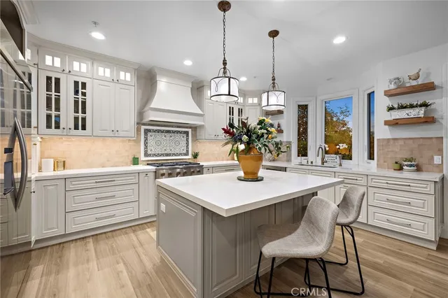 a kitchen with a table chairs sink and cabinets