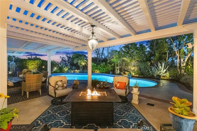 a dining room with furniture water view and a floor to ceiling window