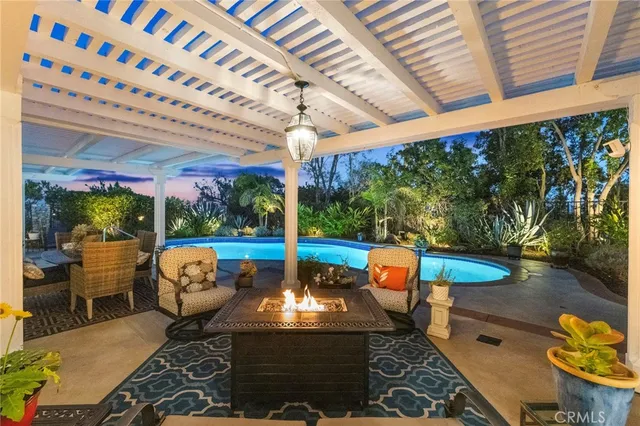 a view of swimming pool with outdoor seating and plants