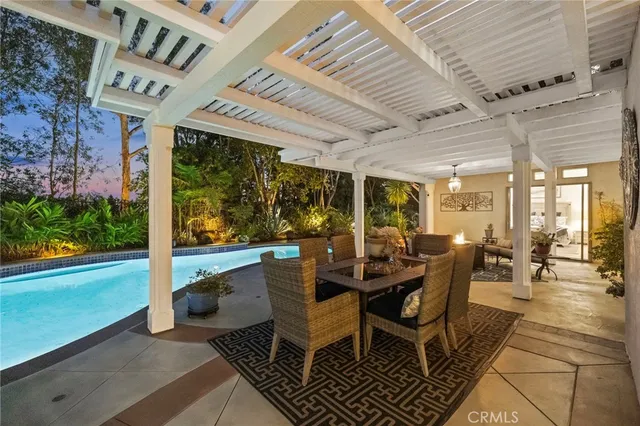 a living room with patio furniture and a floor to ceiling window