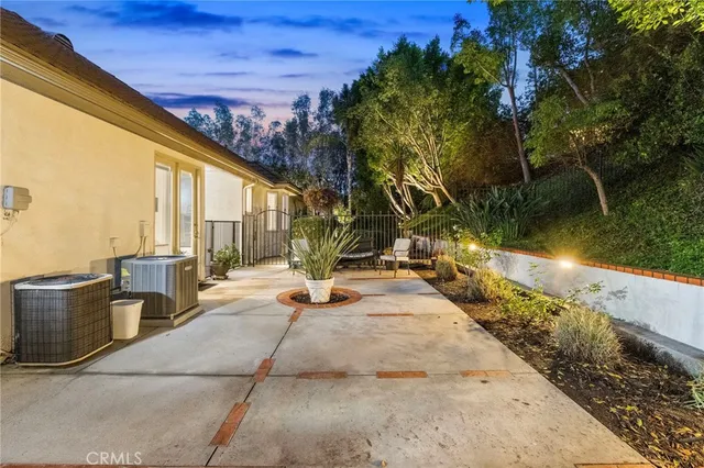 a dining room with furniture water view and a floor to ceiling window