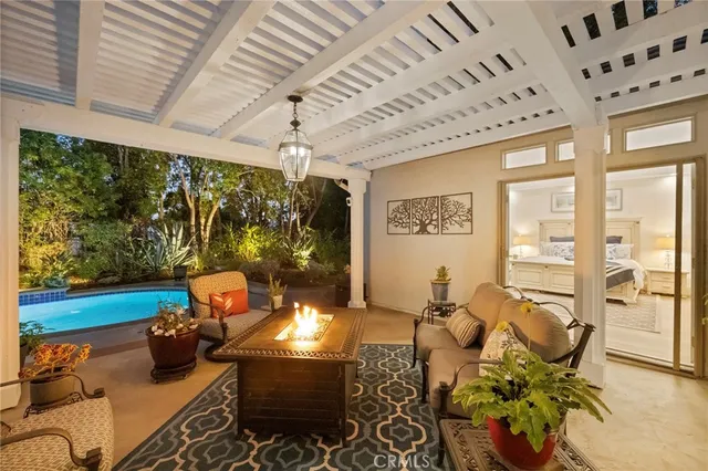 a view of a patio with table and chairs potted plants with wooden floor and fence