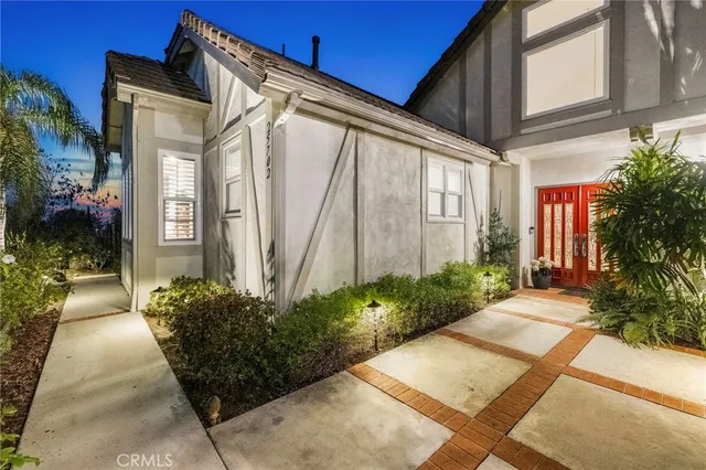 a view of a house with potted plants