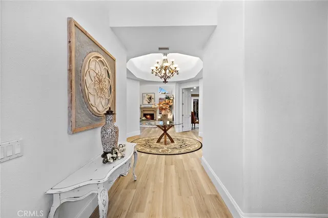 a room with a table and a chandelier