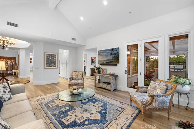 a living room with furniture a flat screen tv and a table