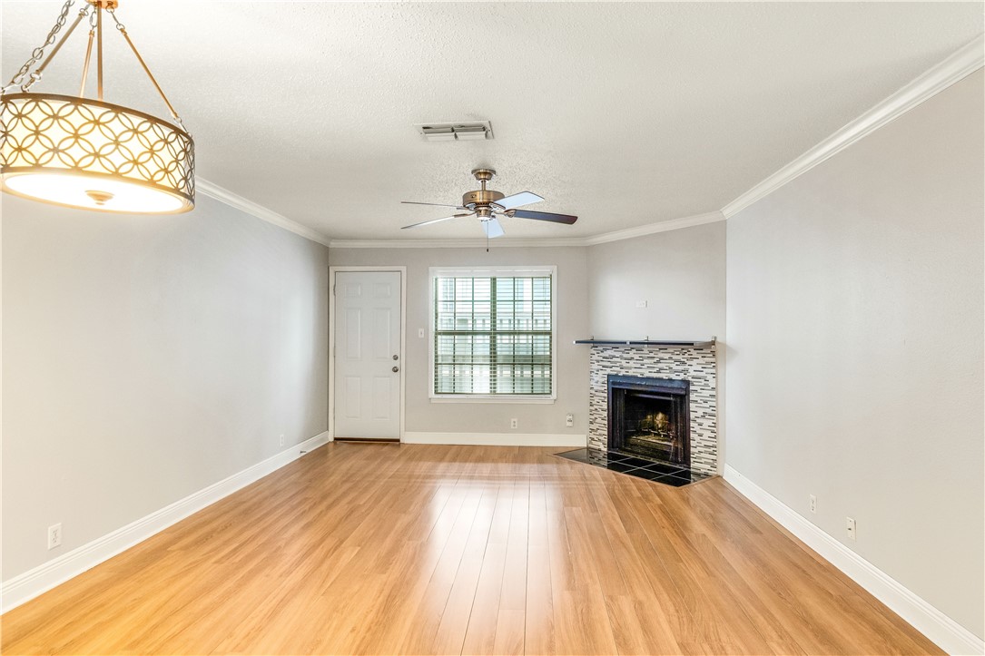 an empty room with a fireplace and wooden floor
