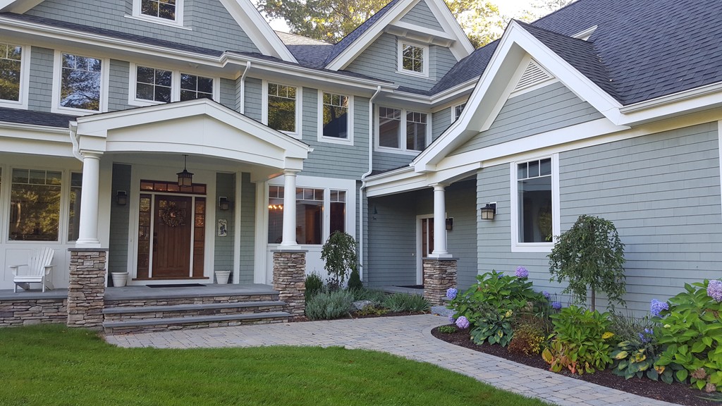 a front view of a house with a garden