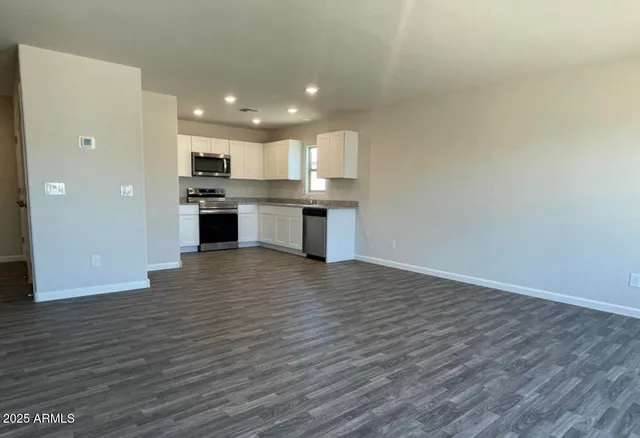a view of kitchen with kitchen island microwave and stove