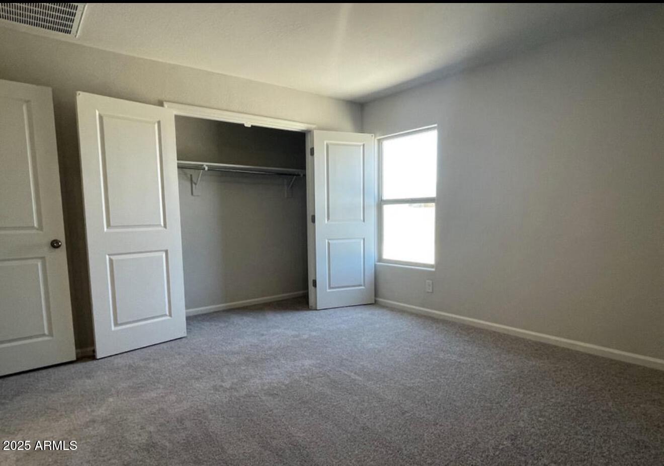 251 South Picacho Heights Road Eloy, AZ 85131 - Photo 15 of 19 an empty room with closet and windows