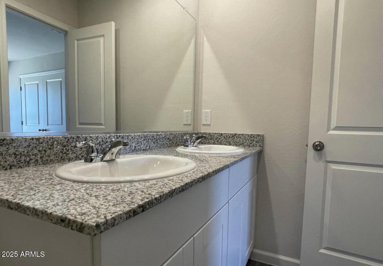 251 South Picacho Heights Road Eloy, AZ 85131 - Photo 17 of 19 a bathroom with a granite countertop sink and a mirror