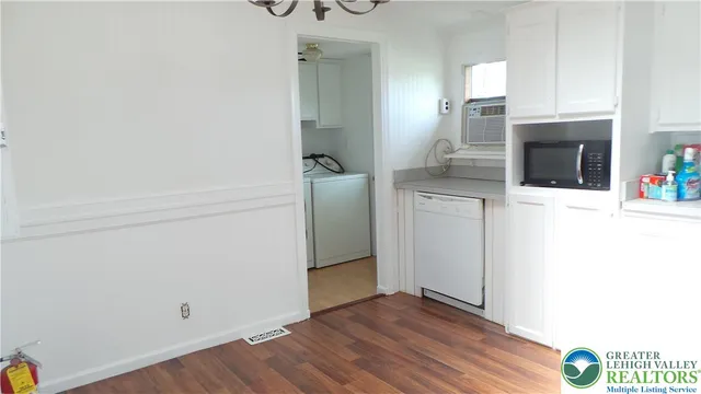 a view of a kitchen with wooden floor
