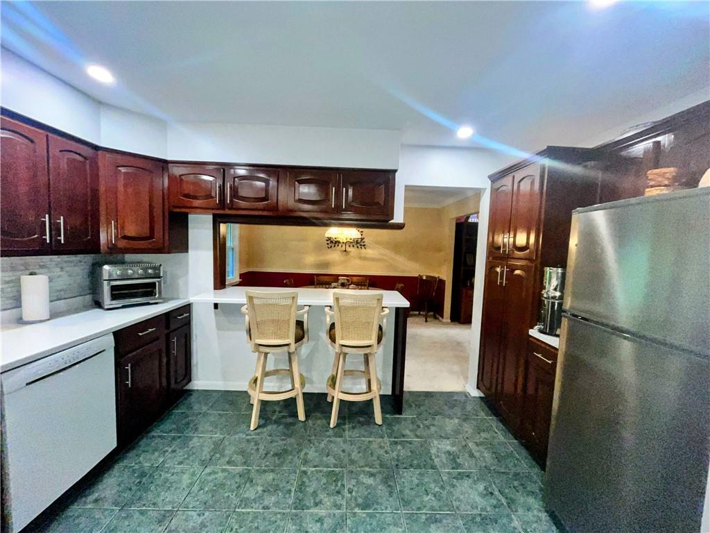1260 Lions Health Camp Road Indiana, PA 15701 - Photo 9 of 34 a kitchen with stainless steel appliances granite countertop a refrigerator a stove a sink and a dining table