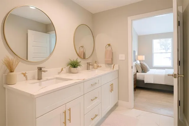 a large bed sitting in a bedroom next to a window