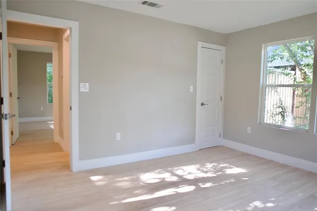 a bedroom with bed and a window