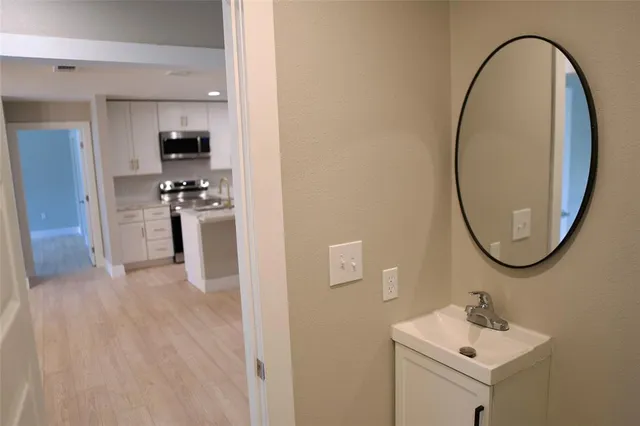 a view of a big room with windows and chandelier fan