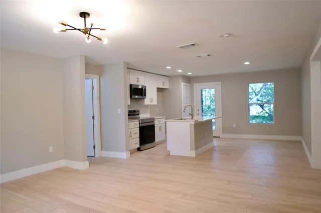 a backyard of a house with fire pit and outdoor seating