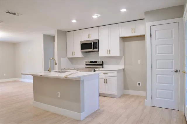a living room with furniture kitchen view and a window