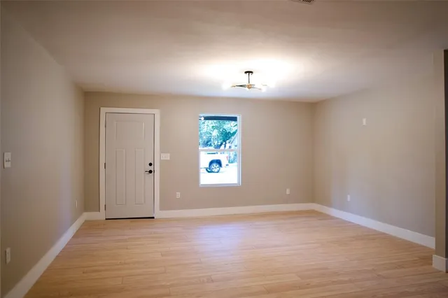 a kitchen with kitchen island granite countertop a sink a stove a microwave a counter top space and cabinets