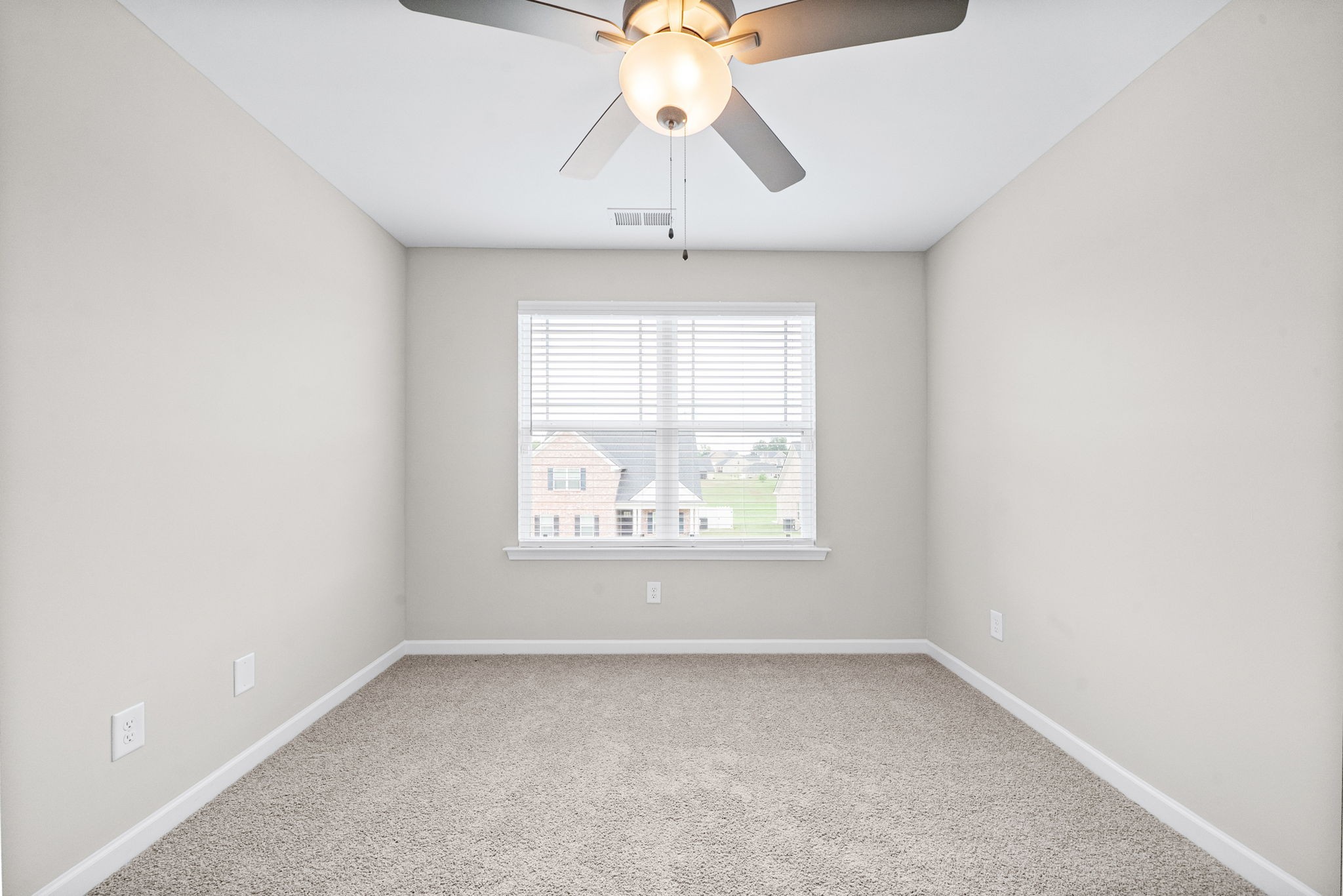 719 Reflections Lane Pleasant View, TN 37146 - Photo 24 of 46 an empty room with a window and a chandelier fan