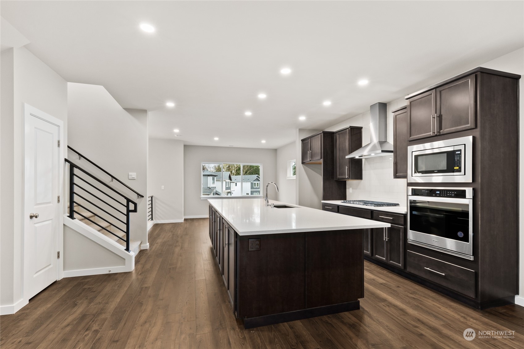 327 207th Street Southeast Bothell, WA 98012 - Photo 13 of 31 a kitchen with a sink stainless steel appliances and wooden floor